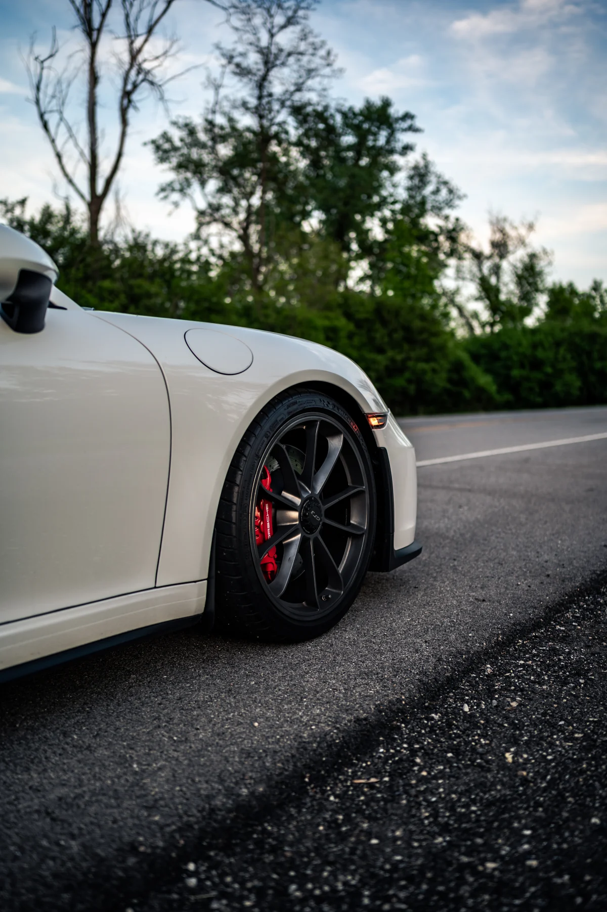 Wheel and brake detail of a white Porsche 911 GT3 (991.2)